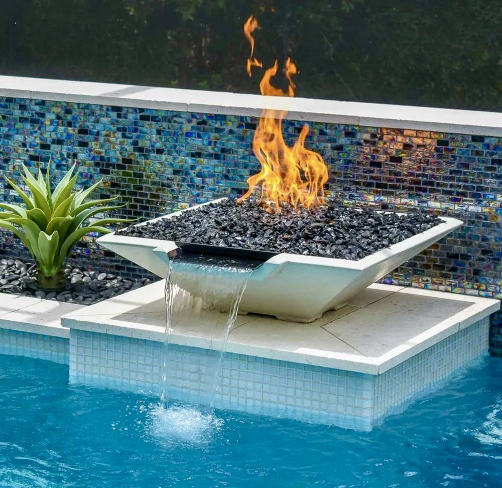 Fire bowl with water scupper over a glass-tile wall