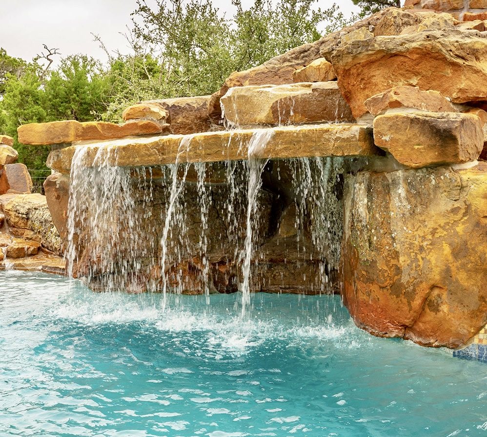 Rock grotto waterfall spilling into a pool