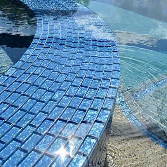 Blue mosaic tile on a curved spa wall