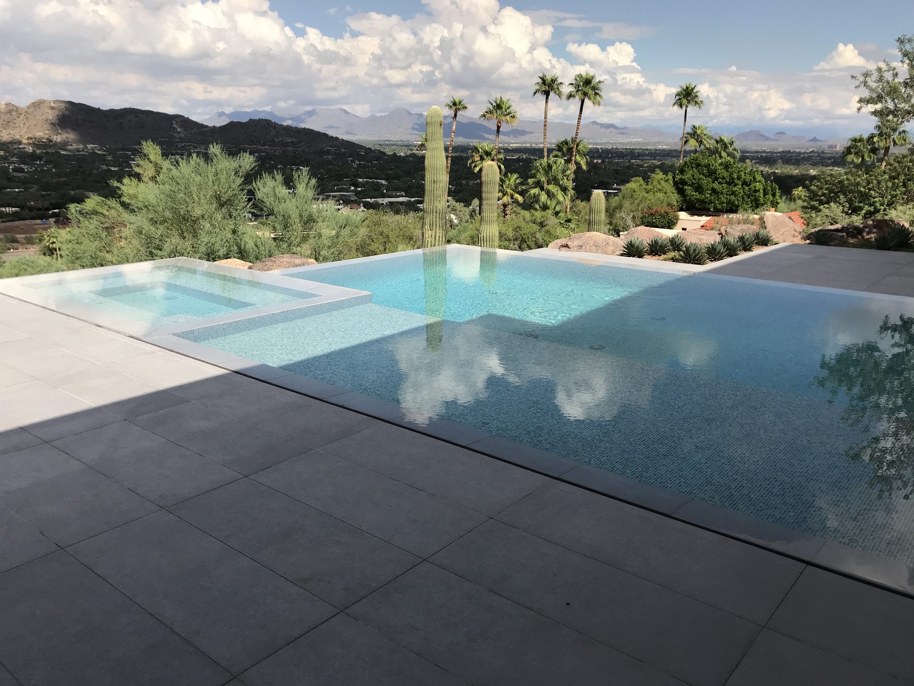Negative-edge pool and spa with desert mountain views — Standard Pools project