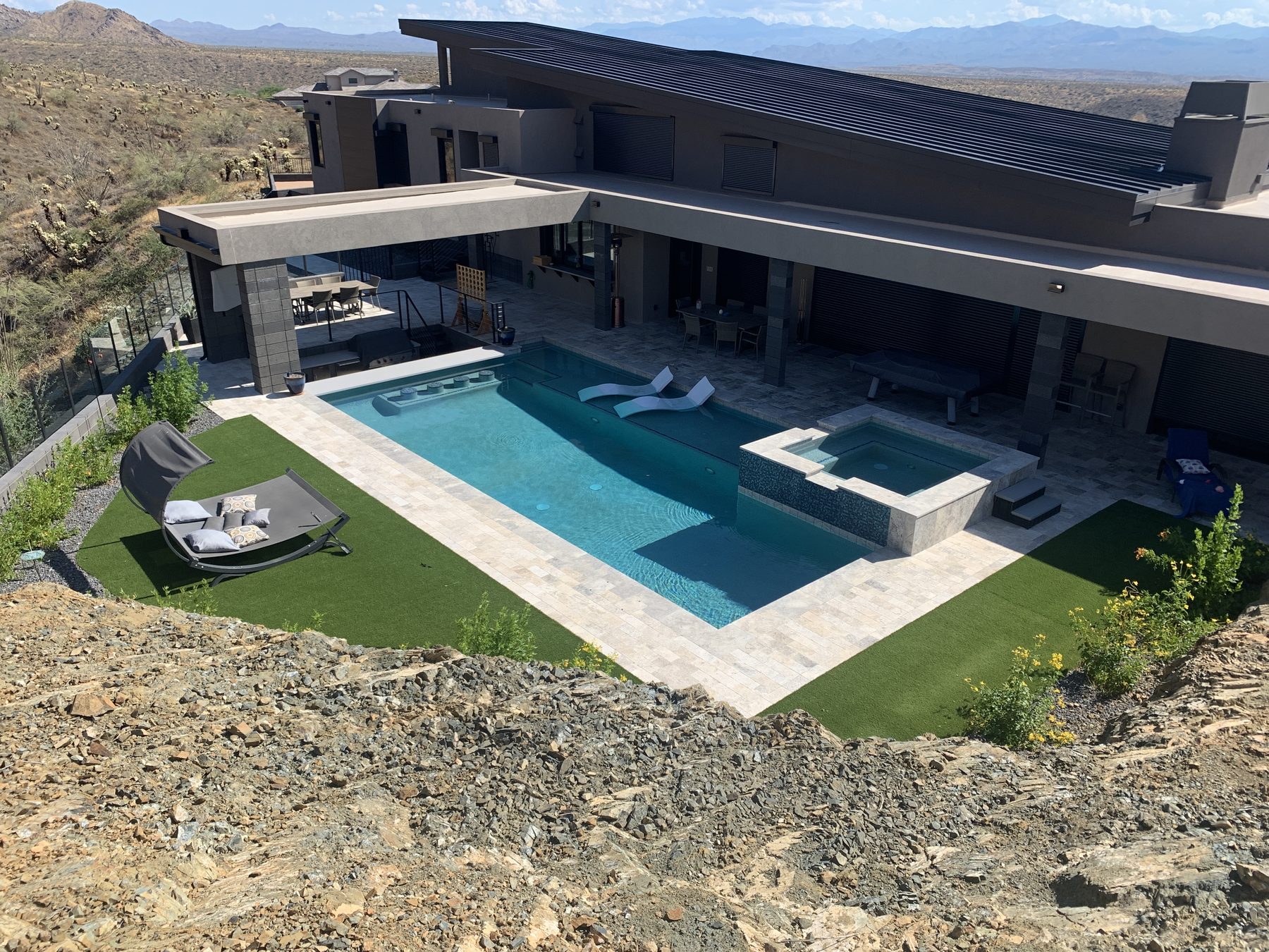 Hillside build with retaining walls below pool and spa — Standard Pools project