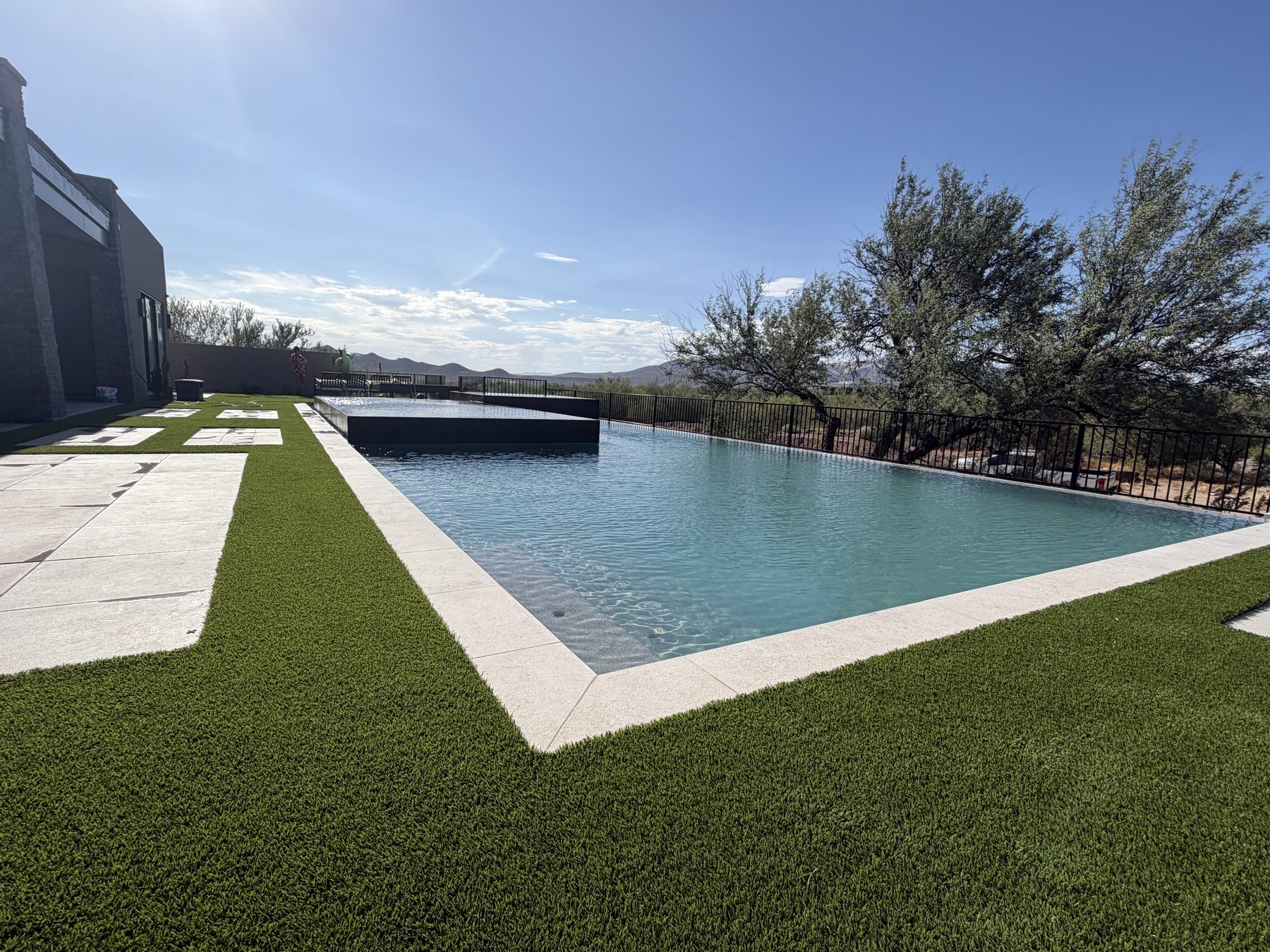 Long modern pool with fresh interior finish and turf border — Standard Pools project