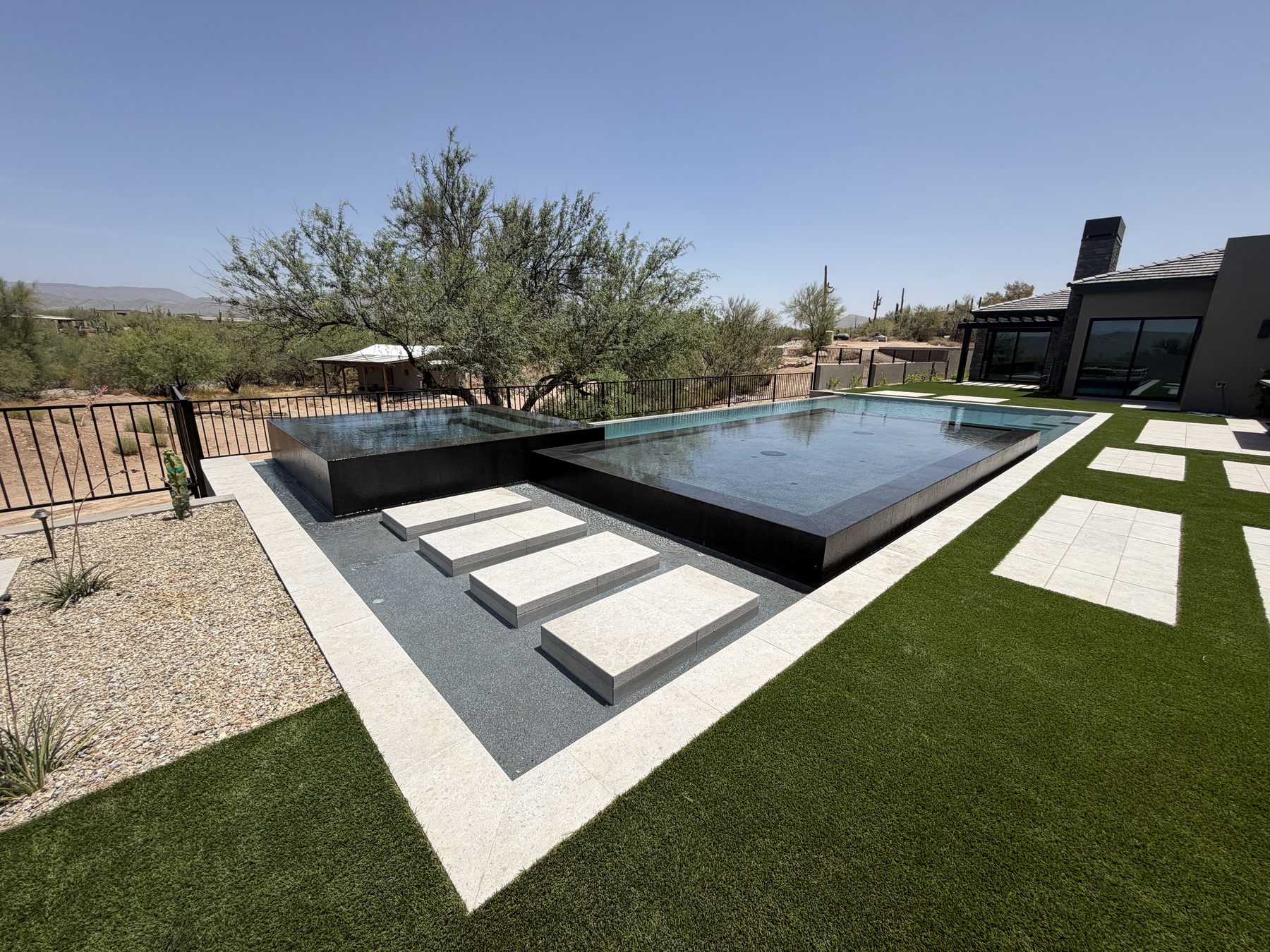 Elevated dark-edge spa and pool with desert views — Standard Pools project