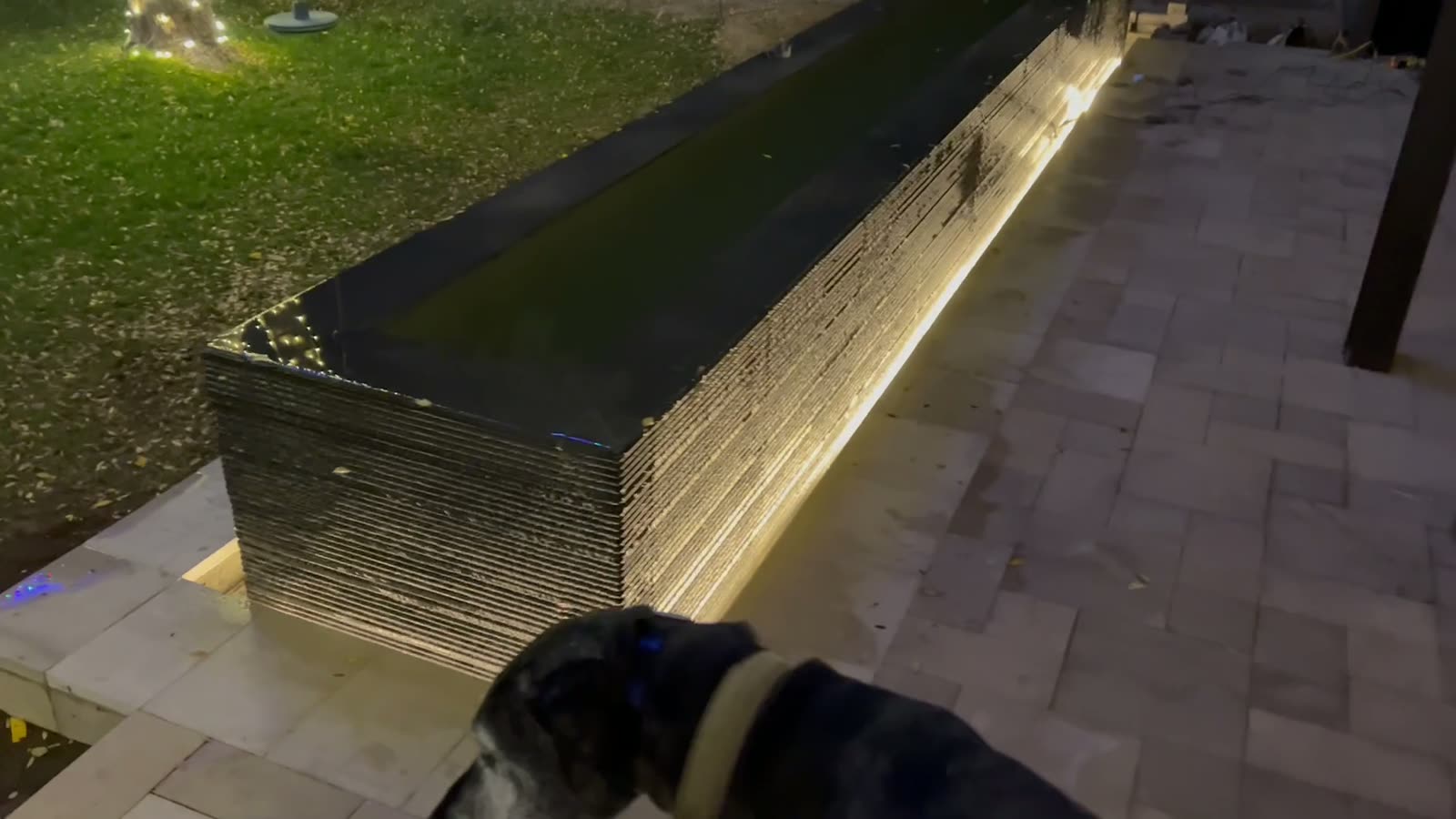 Illuminated water feature and landscape lighting at night — Standard Pools project