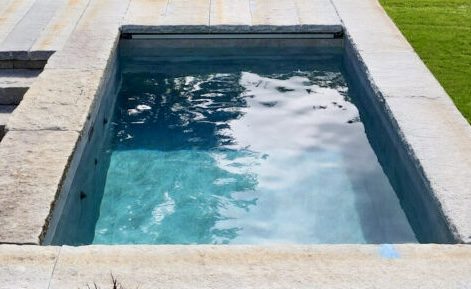 Rectangular cold plunge with stone coping