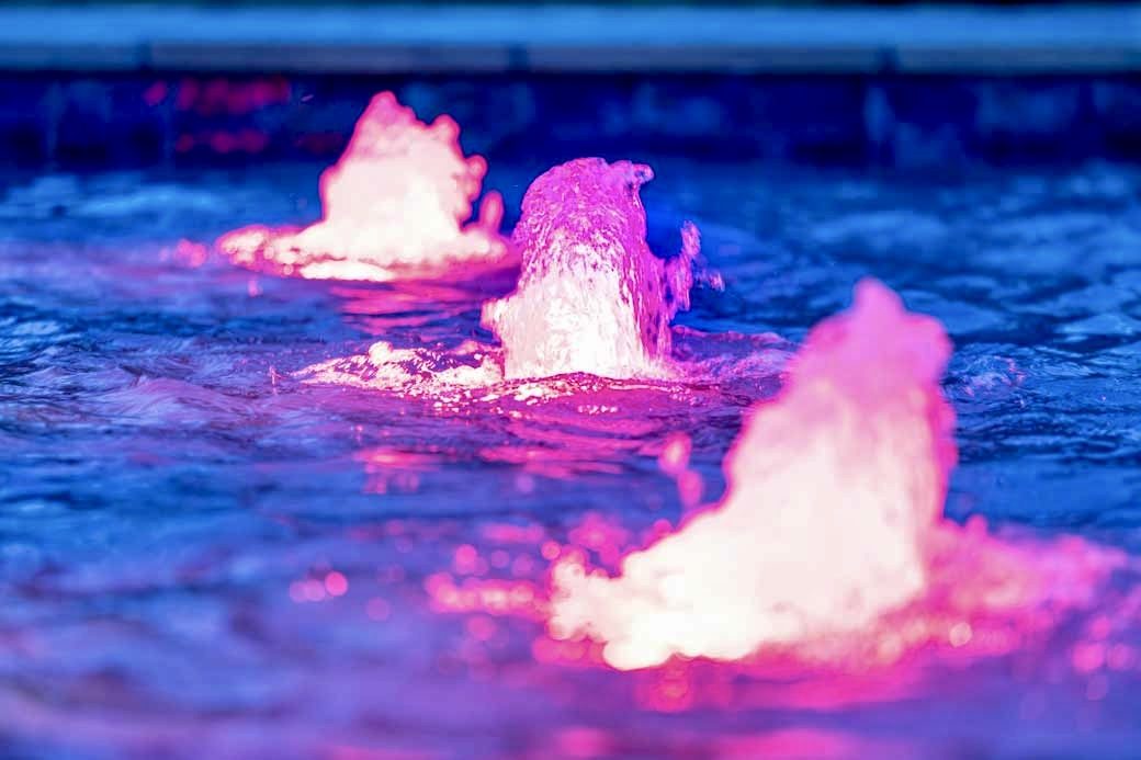Color LED bubblers glowing on a shallow shelf at night